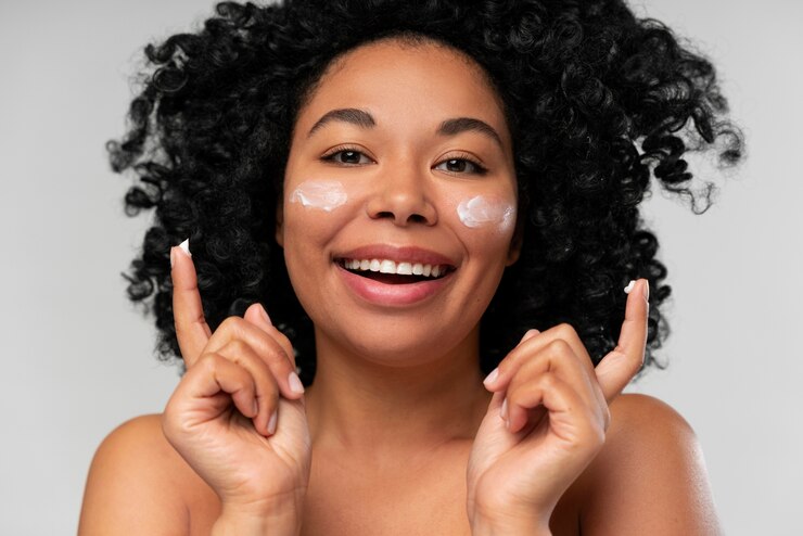 woman using moisturizer on her face as a skincare routine