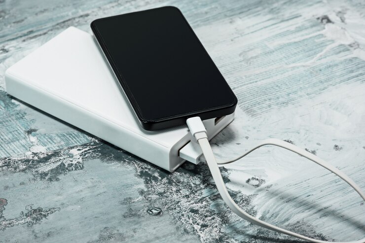 picture showing powerbank charging a mobile device of a solo traveler