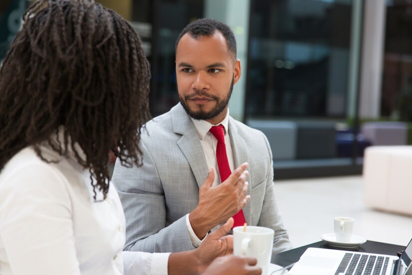 Picture showing a young man informing his stakeholder about his leave