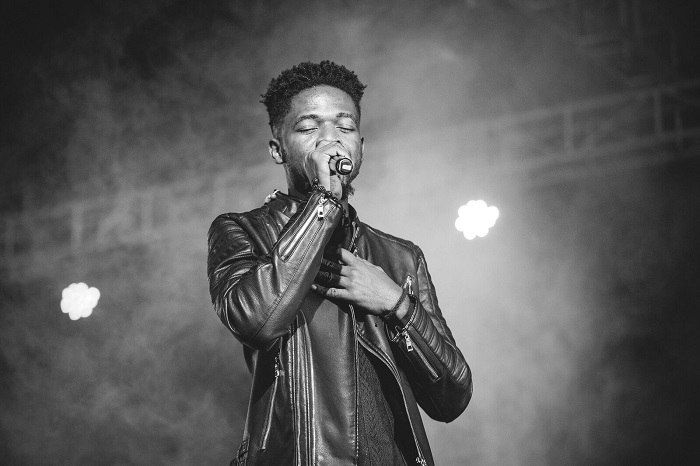 picture showing Johnny Drille on stage at one of his concerts 