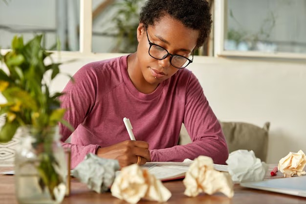 picture showing a lady writing down her plans and goals for 2025