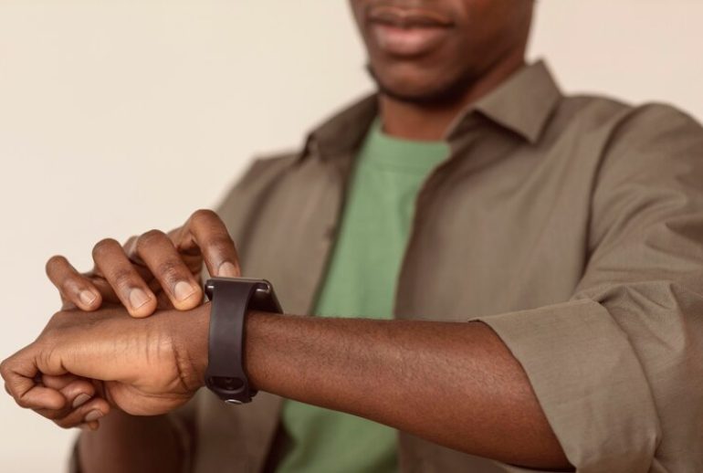 picture showing a man checking his wristwatch for time